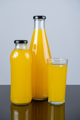 Bottle of orange juice and oranges