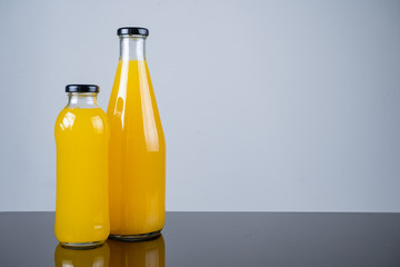 Bottle of orange juice and oranges