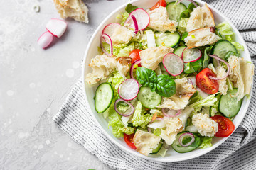 Vegetarian fattoush salad. Traditional Middle Eastern salad with toasted pita bread and vegetables. Lebanese cuisine.