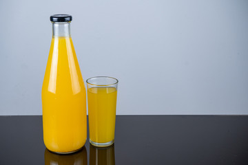 Bottle of orange juice and oranges