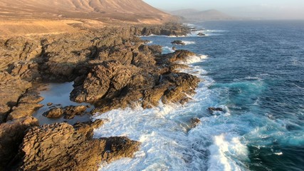 Walkuing along the coast contempalting the wonders of nature with its natural swimming pools and its ocean