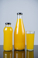 Bottle of orange juice and oranges