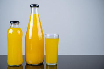 Bottle of orange juice and oranges