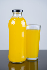 Bottle of orange juice and oranges