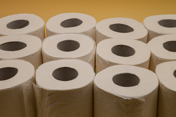 White toilet paper for the bathroom with yellow background