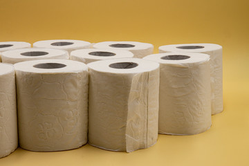 White toilet paper for the bathroom with yellow background