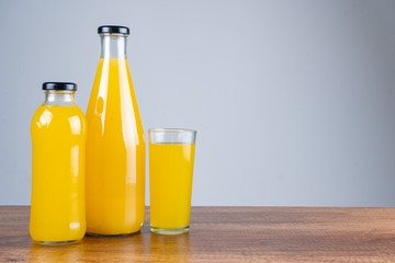Bottle of orange juice and oranges