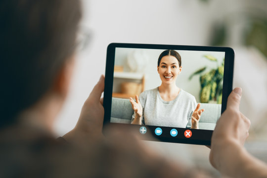 man is using tablet pc for remote conversation
