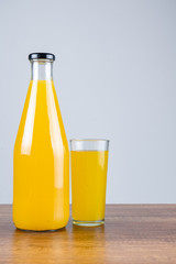 Bottle of orange juice and oranges