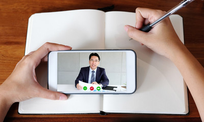 Study online class, Woman hand writing on notebook while using mobile phone for e learning, Adult female student in digital education class by smartphone, social distancing, work from home   concept