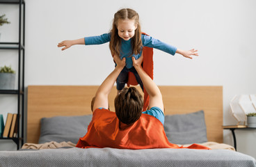 Girl and daddy in Superhero costume