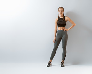 Woman in fashionable sportswear is doing exercise.