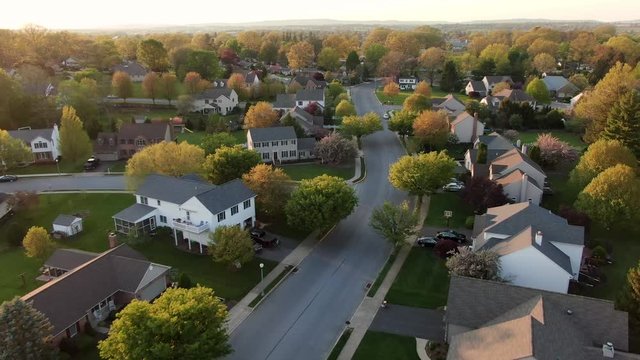 Real estate industry, small town community, neighborhood in America aerial establishing shot, spring sunset