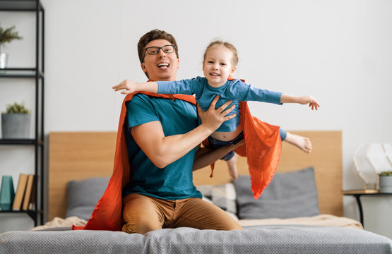 Girl and daddy in Superhero costume