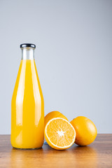 Bottle of orange juice and oranges
