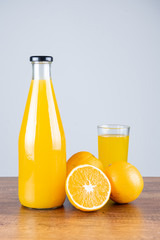 Bottle of orange juice and oranges