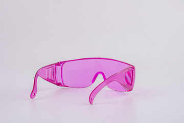 pink safety glasses isolated on white background.