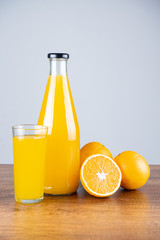 Bottle of orange juice and oranges