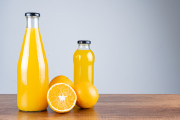 Bottle of orange juice and oranges