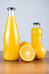 Bottle of orange juice and oranges