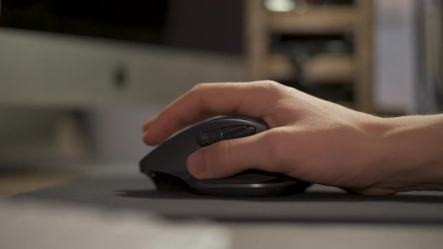 Hand Moving The Computer Mouse On The Mouse Pad - closeup shot