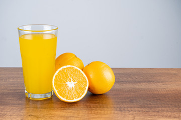 glass of orange juice and orange