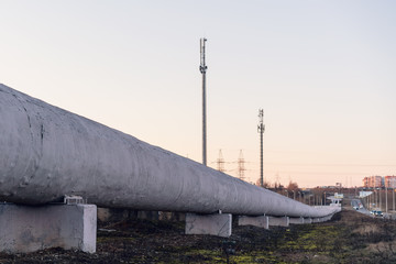 central heating system pipes covered with insulation under blue sky in spring