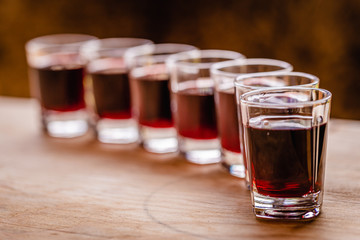 red alcohol shots in small glasses on a celebration