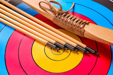 Arrows and bow for archery on target, closeup