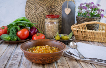 Traditional Georgian Kharcho soup with meat and rice on old wooden background.