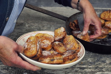 Traditional Austrian desert „Pofesen“ (french toast with sugar and plum jam) served in an iron pan on an alpine hut
