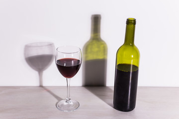 Shadow of wine glass in dark light.