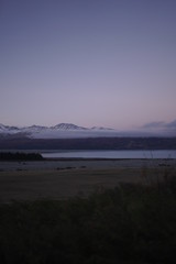 Beautiful view of Mountains and low clouds during winter at sunset in New zealand
