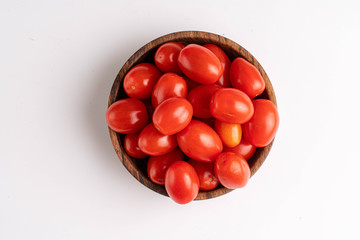 cherry tomatoes on wooden plate