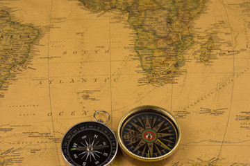 Plakat Compasses on old map of the world. Journey and discovery concept