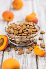 Vintage wooden table with shelled Apricot Kernels (selective focus)