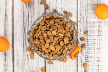 Vintage wooden table with shelled Apricot Kernels (selective focus)
