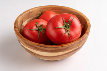 tomatoes in wooden bowl