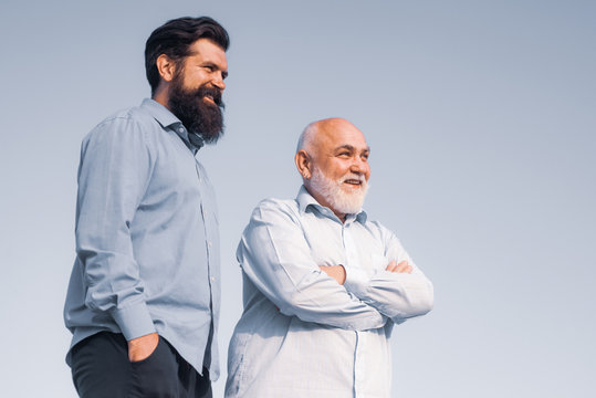 Handsome Senior Men In Blue Shirt. Portrait Of Two Bearded Men. Grandfather Ageing. Male Multi Generation Family Walking. Fatherhood.