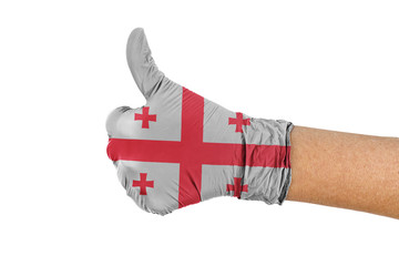Georgia flag on a medical glove showing thumbs up sign