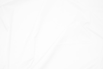 Obraz premium White fabric cloth background abstract with soft waves , flowing draped cloth in rippled elegant curves and wrinkled creases , soft focus, textured background and abstract