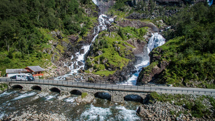 Fototapeta na wymiar Latefoss waterfall in Norway. Twin waterfall top view. Waterfall near the road. The famous Norwegian Latefossen waterfall in Hargarden park 