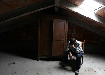 depressed and pensive lonely person sitting in a attic