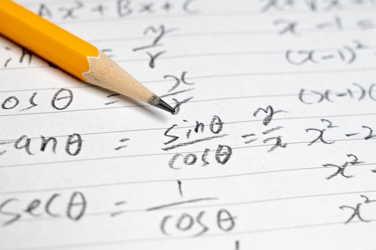 Educational concept background with mathematical formulas and pencils.