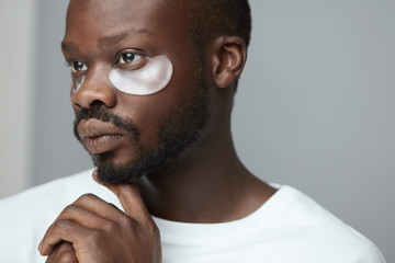 Skincare Beauty Routine. Black Under Eye Patches On Male Model. Cosmetic Mask On Face. Cosmetology Facial Treatment.