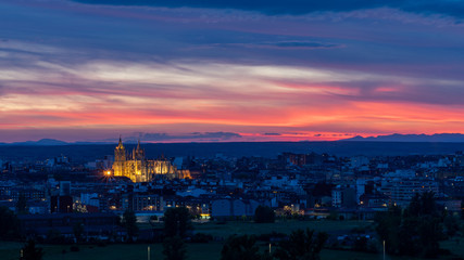 Panoramic photograph of the city of Leon, Spain. It is seen during the start of the blue hour with a spectacular sky and the illuminated Cathedral