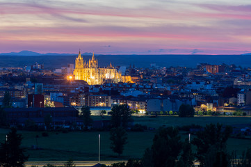 Obraz premium Photograph of the city of Leon, Spain. It is seen during the start of the blue hour with a spectacular sky and the illuminated Cathedral
