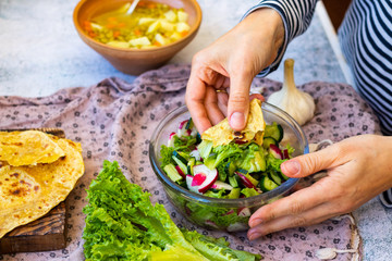 Fresh vegetables salad - radish, lettuce, cucumber, salad leaves. Vegan healthy food