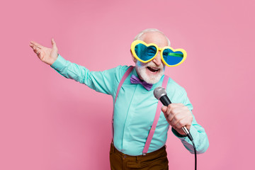 Photo of funny stylish grandpa positive emotions holding karaoke microphone singing party songs...