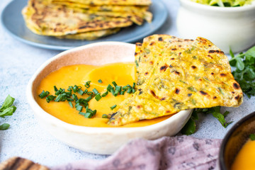 Yellow chickpea beans hummus dip with flatbread tortillas. Vegan food
